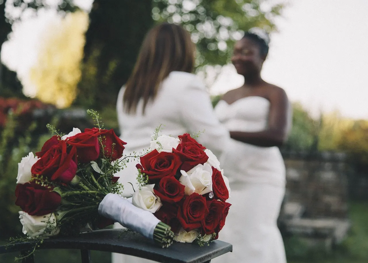 A newly married couple carrying roses
