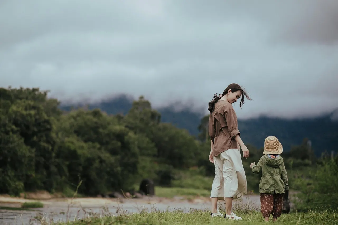A parent and child sharing time outdoors