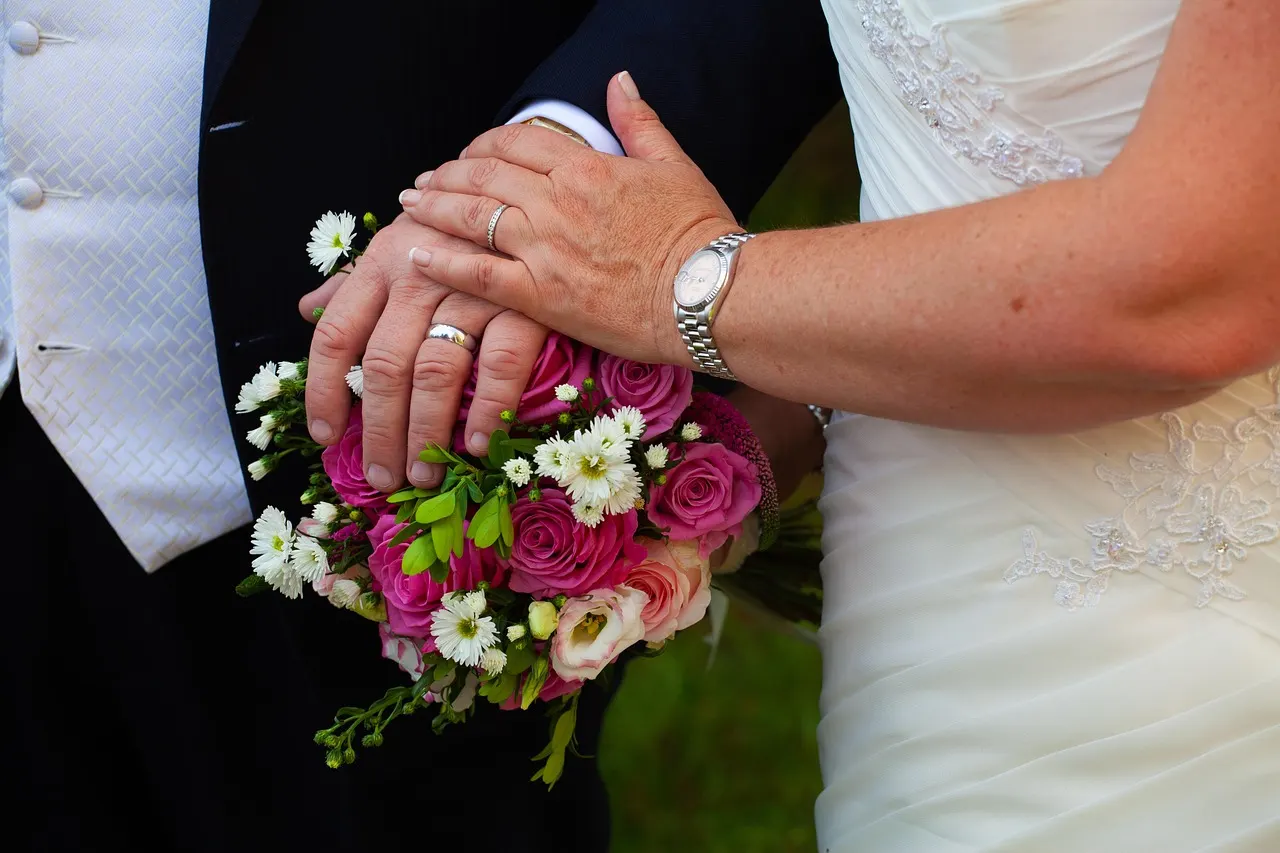 Wedding rings resting in two open hands